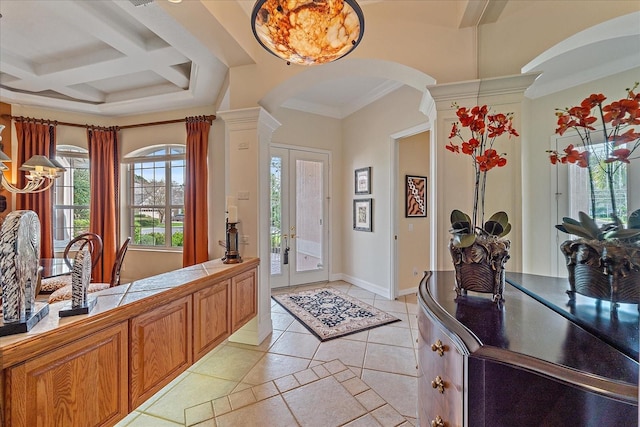 entryway featuring arched walkways, beam ceiling, ornamental molding, coffered ceiling, and baseboards