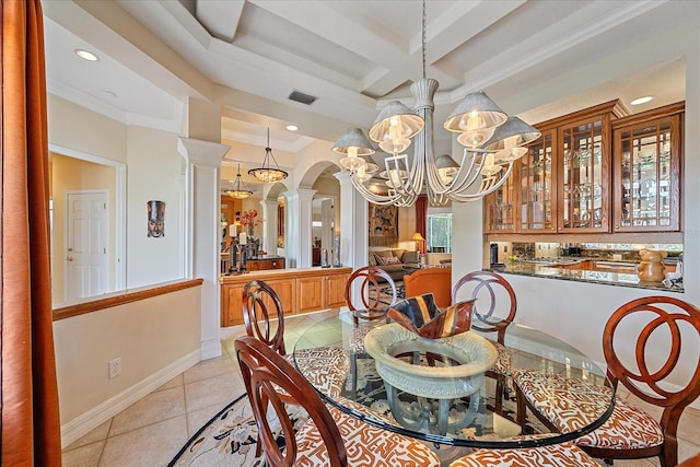 dining space with arched walkways, light tile patterned floors, a notable chandelier, coffered ceiling, and decorative columns