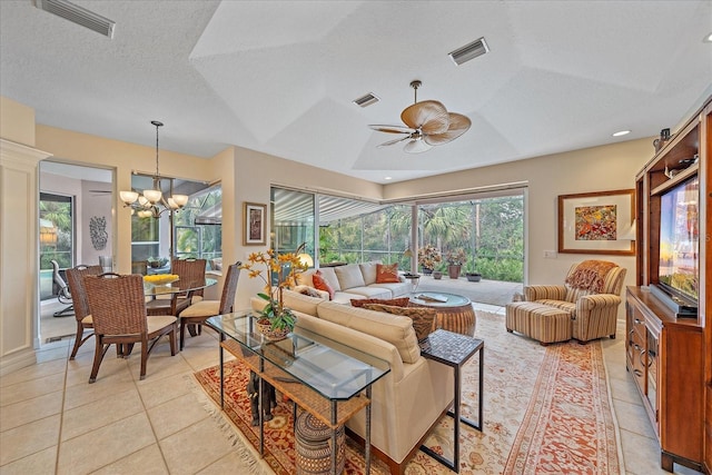 living area featuring a textured ceiling, light tile patterned flooring, and visible vents