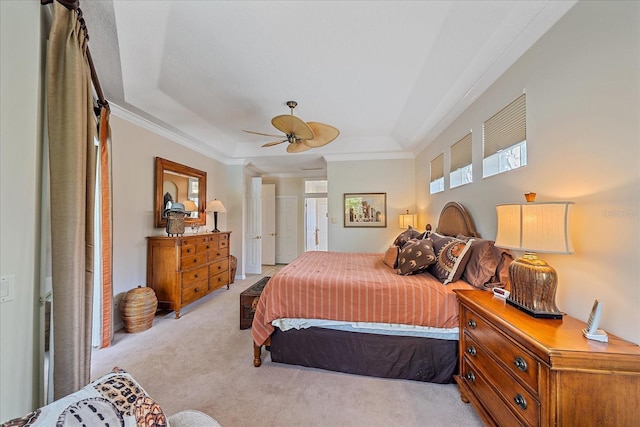 bedroom featuring a raised ceiling, crown molding, and light colored carpet