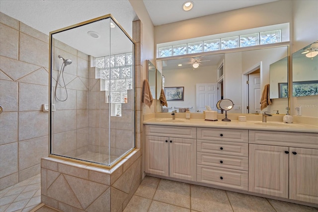 bathroom featuring double vanity, a sink, and walk in shower