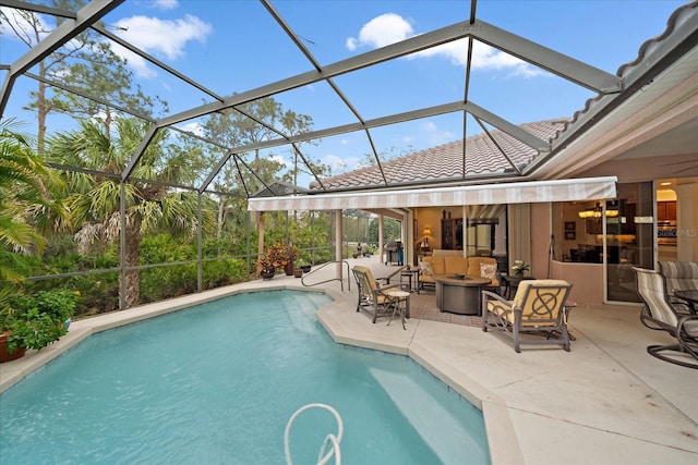 pool with a lanai, a patio, and an outdoor living space with a fire pit