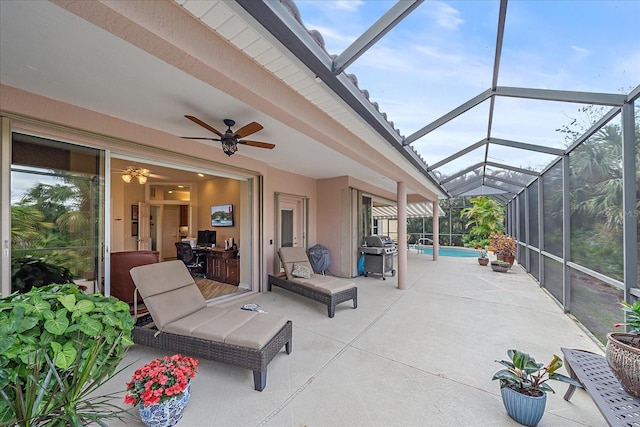 view of patio featuring a ceiling fan, a lanai, an outdoor pool, and grilling area