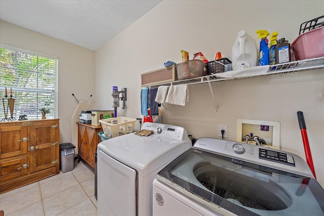 6617 Nautical Dr, Lakewood Ranch, FL 34202 - laundry room with laundry area, washing machine and dryer, light tile patterned floors, and a textured ceiling
