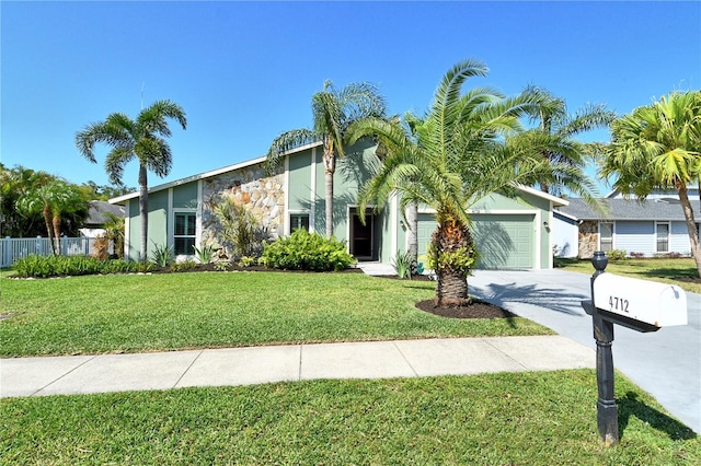 view of front of home featuring an attached garage, a front lawn, stucco siding, and driveway