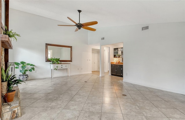 unfurnished living room featuring high vaulted ceiling, a ceiling fan, light tile patterned flooring, and visible vents