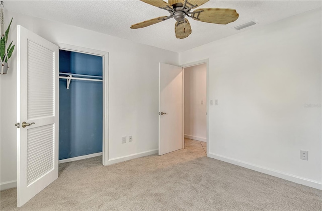unfurnished bedroom featuring ceiling fan, carpet floors, baseboards, visible vents, and a closet
