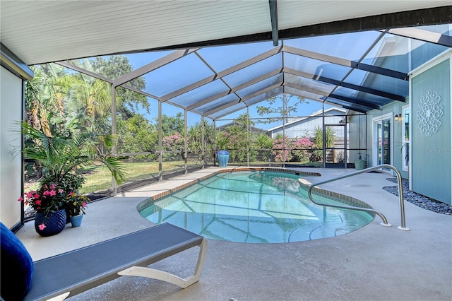outdoor pool featuring a patio area and a lanai