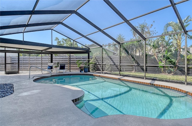 outdoor pool with a patio, a lanai, and a fenced backyard