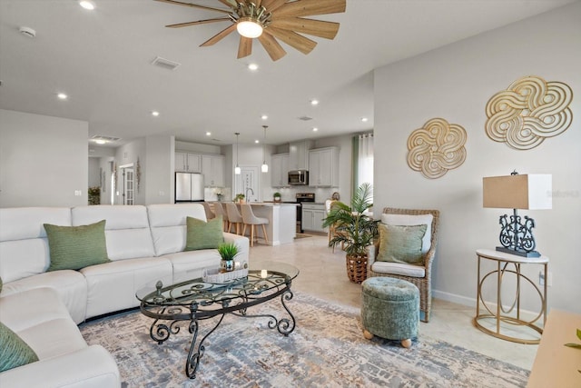 living area with light tile patterned floors, baseboards, visible vents, and recessed lighting