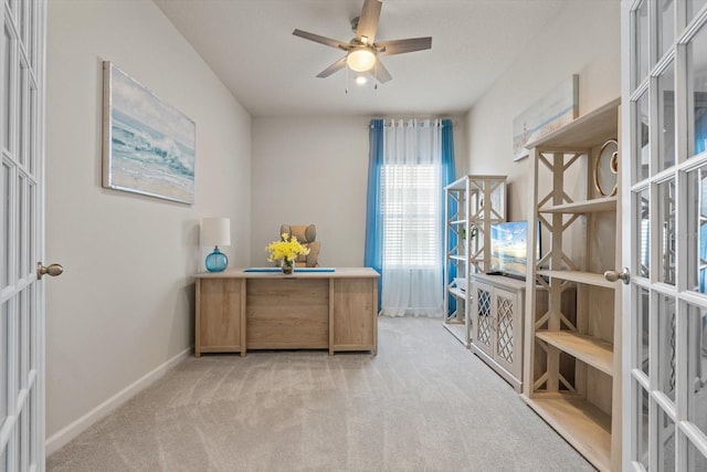 carpeted home office featuring a ceiling fan, french doors, and baseboards