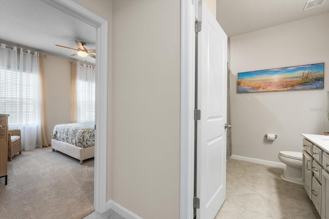 bathroom featuring baseboards, visible vents, connected bathroom, toilet, and vanity