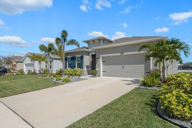 view of front facade with a front lawn, driveway, an attached garage, and stucco siding