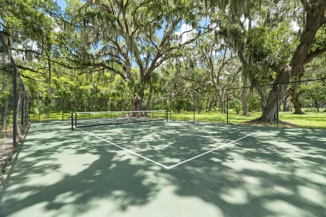 view of tennis court featuring fence