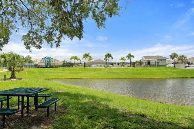 view of community with a yard and a water view