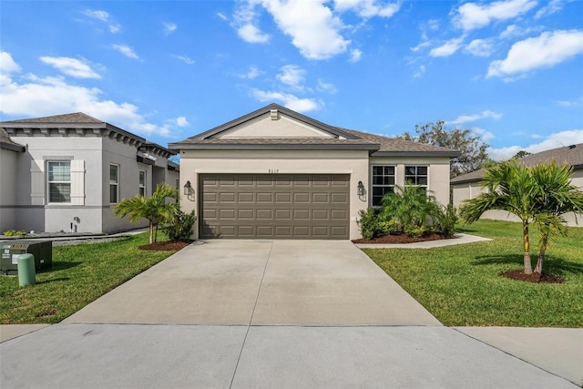 single story home with a garage, concrete driveway, a front yard, and stucco siding