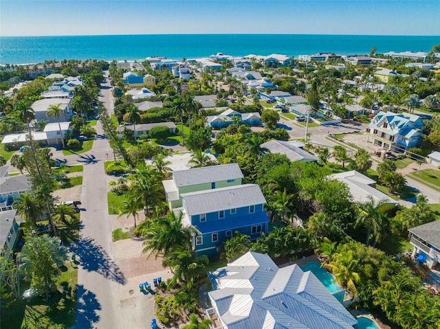 drone / aerial view featuring a water view and a residential view