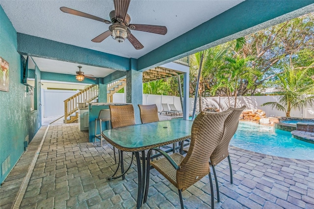 sunroom / solarium featuring ceiling fan