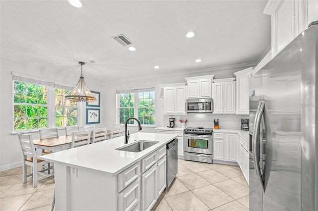 kitchen featuring a center island with sink, light countertops, visible vents, appliances with stainless steel finishes, and a sink