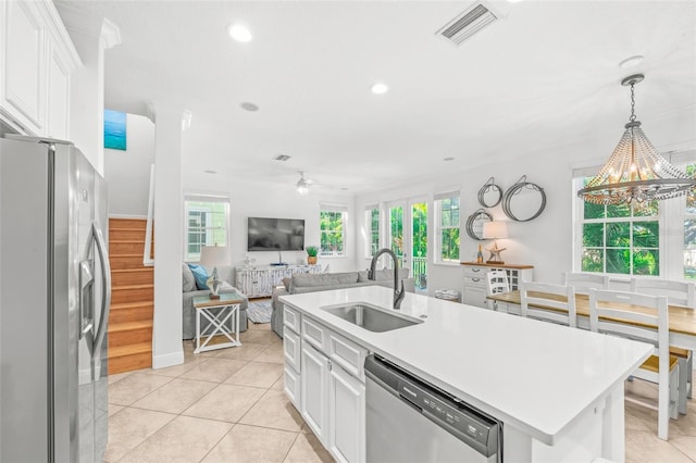 kitchen featuring appliances with stainless steel finishes, visible vents, a sink, and white cabinetry