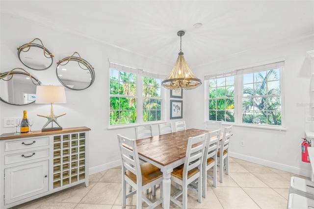 dining area with light tile patterned floors, plenty of natural light, and ornamental molding