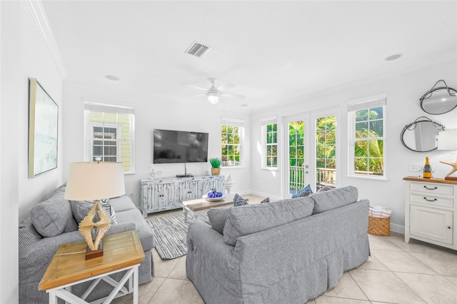 living room with french doors, visible vents, ornamental molding, light tile patterned flooring, and baseboards