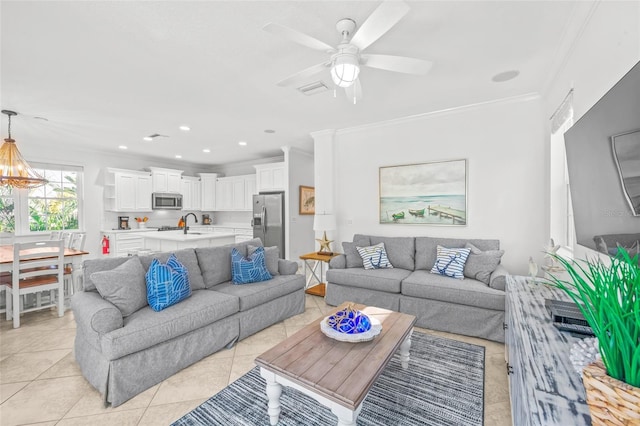 living area with light tile patterned floors, ceiling fan, ornamental molding, and recessed lighting