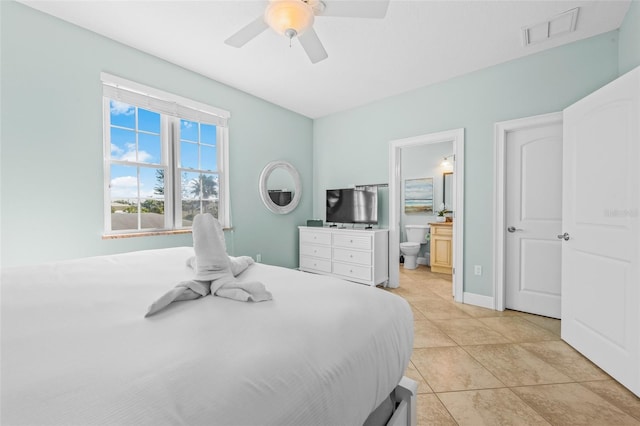 bedroom with visible vents, a ceiling fan, light tile patterned flooring, ensuite bath, and baseboards