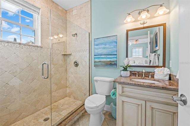 bathroom featuring tile patterned flooring, toilet, vanity, a stall shower, and ensuite bath