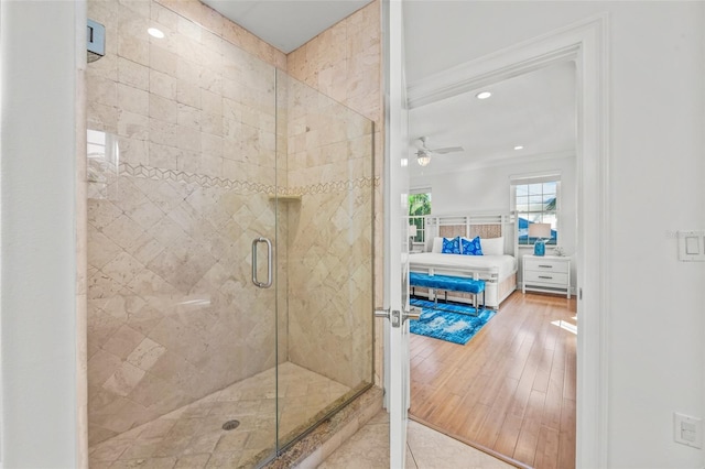 full bath with ceiling fan, wood finished floors, crown molding, a shower stall, and recessed lighting