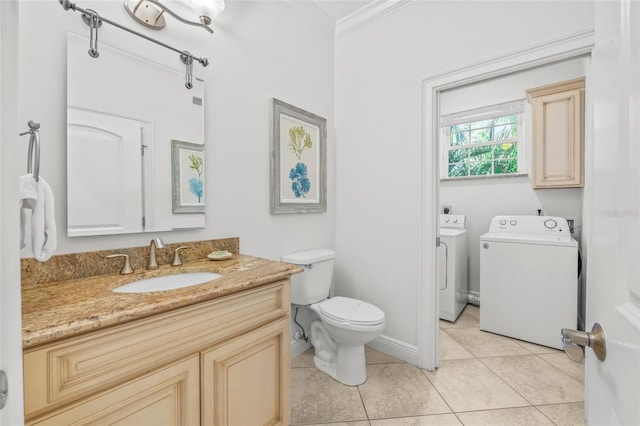 bathroom featuring washer and clothes dryer, toilet, ornamental molding, tile patterned floors, and vanity