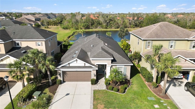 drone / aerial view featuring a residential view and a water view