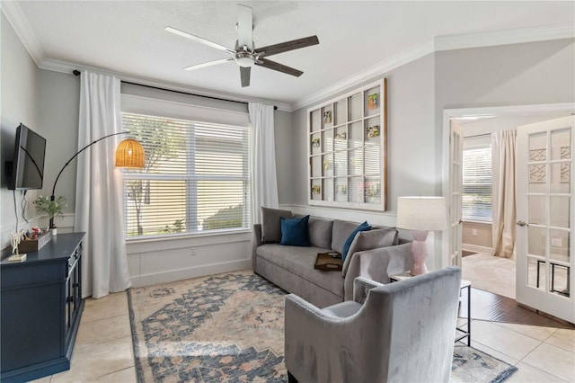 living room featuring light tile patterned floors, plenty of natural light, ceiling fan, and crown molding