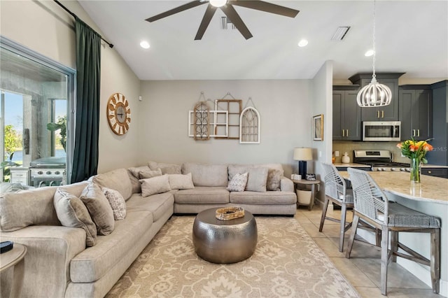 living area featuring light tile patterned floors, visible vents, a ceiling fan, vaulted ceiling, and recessed lighting