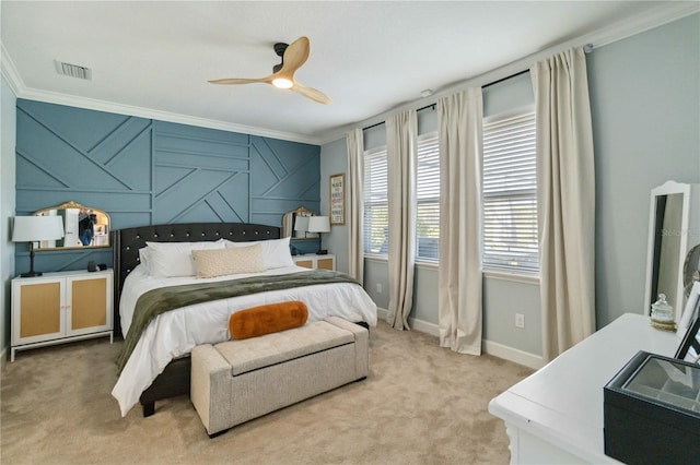 carpeted bedroom featuring visible vents, crown molding, baseboards, and ceiling fan