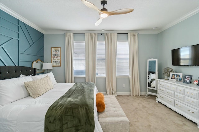 bedroom with ornamental molding, light colored carpet, ceiling fan, and baseboards