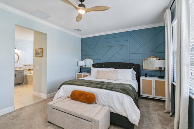 bedroom featuring visible vents, connected bathroom, an accent wall, ornamental molding, and carpet floors