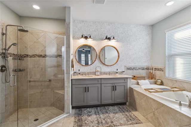 full bath featuring a stall shower, tile patterned floors, a sink, and a bath