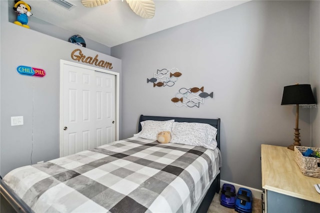 bedroom featuring a closet, carpet flooring, visible vents, and baseboards