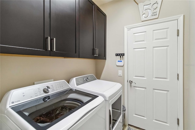 laundry area featuring cabinet space and washer and clothes dryer