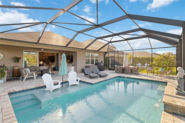 pool with glass enclosure, a patio area, a grill, and an outdoor living space