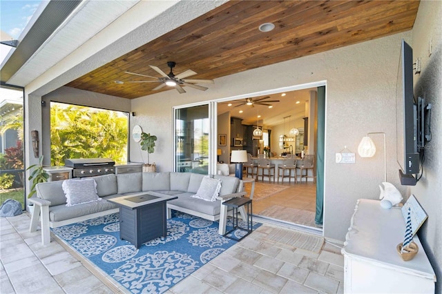 view of patio featuring a grill, an outdoor living space, and a ceiling fan