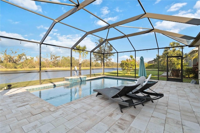 outdoor pool with glass enclosure, a patio area, and a water view