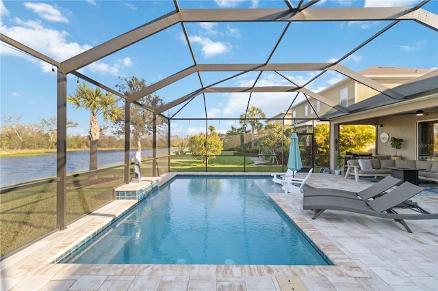 pool with a water view, glass enclosure, a yard, and a patio