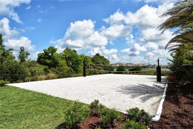 view of property's community featuring a yard and volleyball court