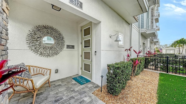 512 Laurel Park Dr, Sarasota, FL 34236 - doorway to property with fence and stucco siding