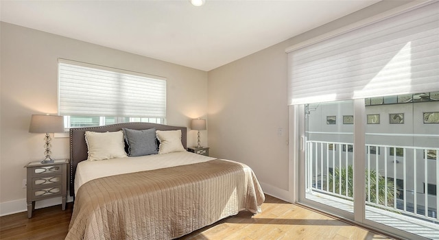 512 Laurel Park Dr, Sarasota, FL 34236 - bedroom with baseboards, wood finished floors, and access to exterior