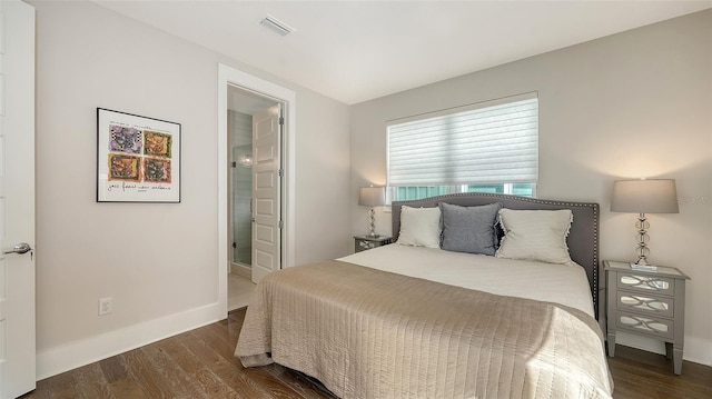 512 Laurel Park Dr, Sarasota, FL 34236 - bedroom with dark wood-style flooring, visible vents, baseboards, and ensuite bathroom