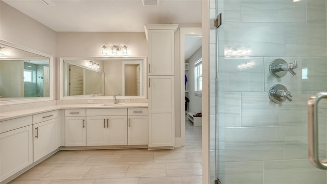512 Laurel Park Dr, Sarasota, FL 34236 - bathroom featuring a stall shower, visible vents, plenty of natural light, and vanity