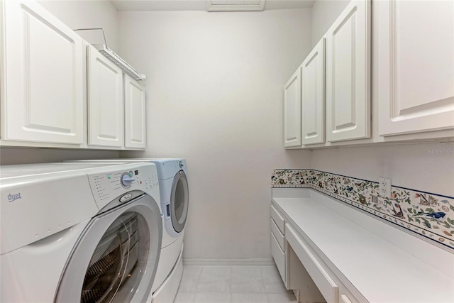 laundry area featuring cabinet space, baseboards, and separate washer and dryer